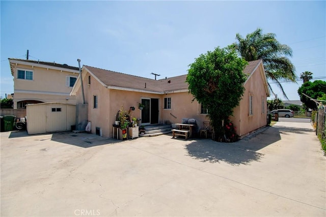 back of house featuring stucco siding, fence, and a patio