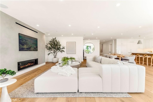 1759 Glenneyre St, Laguna Beach, CA 92651 - living room featuring a glass covered fireplace, recessed lighting, and light wood-style floors