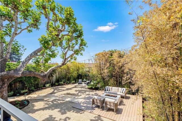 1759 Glenneyre St, Laguna Beach, CA 92651 - view of patio / terrace featuring an outdoor living space with a fire pit, a wooden deck, and fence