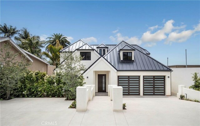 1759 Glenneyre St, Laguna Beach, CA 92651 - view of front of property featuring a standing seam roof, stucco siding, driveway, and metal roof