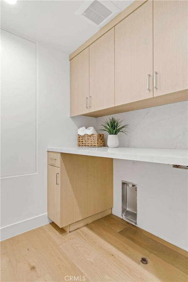 1759 Glenneyre St, Laguna Beach, CA 92651 - washroom with cabinet space and light wood-style floors