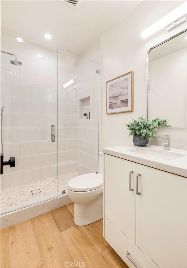 1759 Glenneyre St, Laguna Beach, CA 92651 - bathroom with wood finished floors, a stall shower, toilet, vanity, and recessed lighting