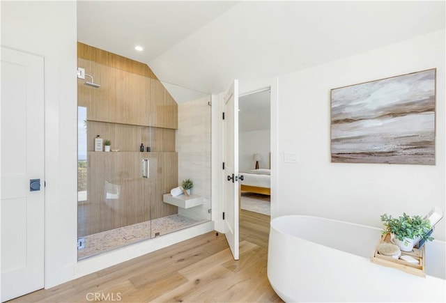 1759 Glenneyre St, Laguna Beach, CA 92651 - ensuite bathroom with a stall shower, a freestanding tub, wood finished floors, vaulted ceiling, and french doors
