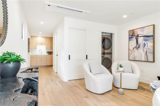 1759 Glenneyre St, Laguna Beach, CA 92651 - living area featuring estacked washer and dryer, light wood finished floors, recessed lighting, and baseboards