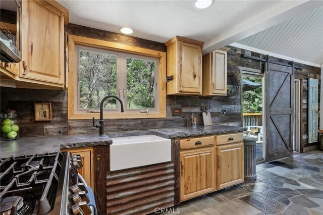 385 Iris Dr, Twin Peaks, CA 92391 - kitchen with a sink, backsplash, stone finish flooring, stainless steel appliances, and light brown cabinetry