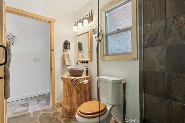 385 Iris Dr, Twin Peaks, CA 92391 - full bathroom featuring stone finish floors, toilet, baseboards, tiled shower, and vanity