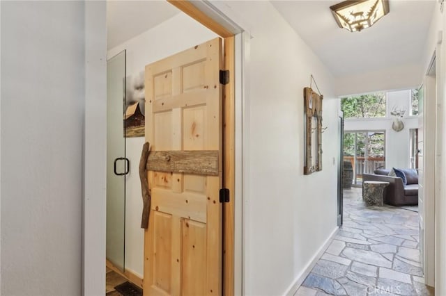 385 Iris Dr, Twin Peaks, CA 92391 - hall featuring light stone finish floors and baseboards