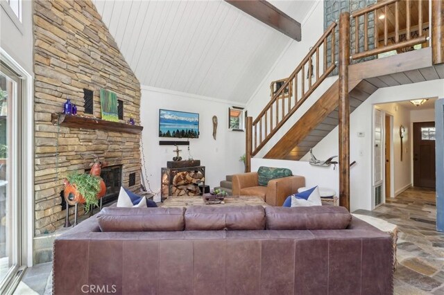 385 Iris Dr, Twin Peaks, CA 92391 - living area with stone finish flooring, stairs, beamed ceiling, a stone fireplace, and high vaulted ceiling