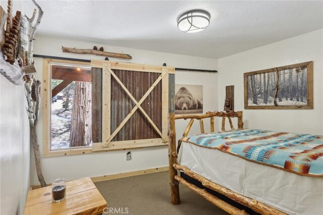 385 Iris Dr, Twin Peaks, CA 92391 - carpeted bedroom featuring a barn door