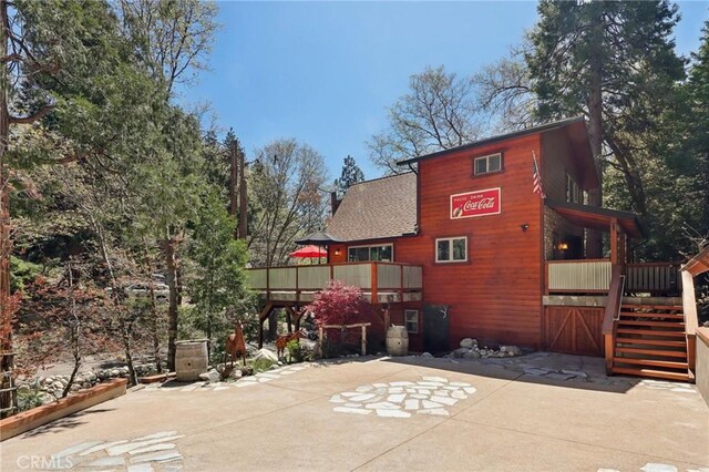 385 Iris Dr, Twin Peaks, CA 92391 - back of house with roof with shingles, stairway, and a deck