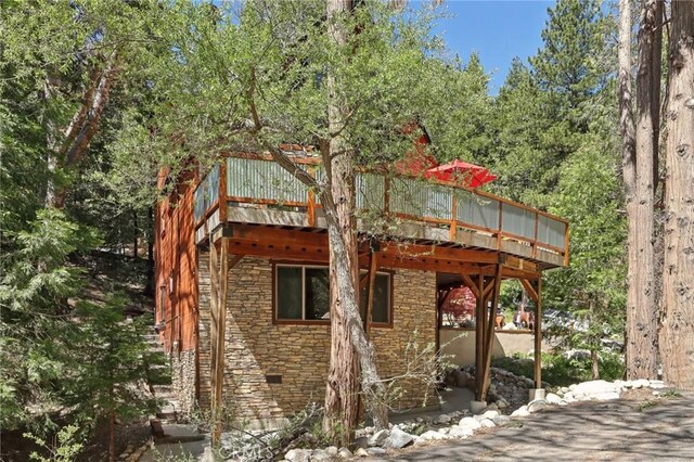 385 Iris Dr, Twin Peaks, CA 92391 - rear view of house with a deck and stone siding
