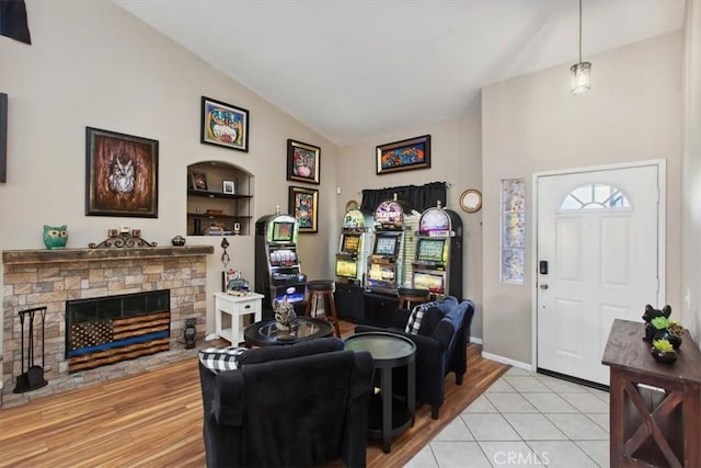 12427 Stardell Ln, Yucaipa, CA 92399 - living area with light wood-type flooring, a stone fireplace, and high vaulted ceiling