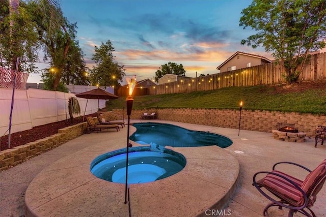 12427 Stardell Ln, Yucaipa, CA 92399 - view of pool featuring an outdoor fire pit, a fenced backyard, a patio, and a pool with connected hot tub