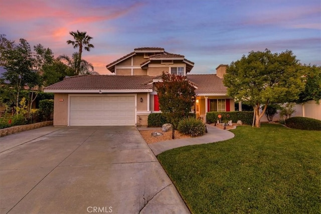 12427 Stardell Ln, Yucaipa, CA 92399 - view of front of house featuring stucco siding, concrete driveway, an attached garage, a tiled roof, and a yard
