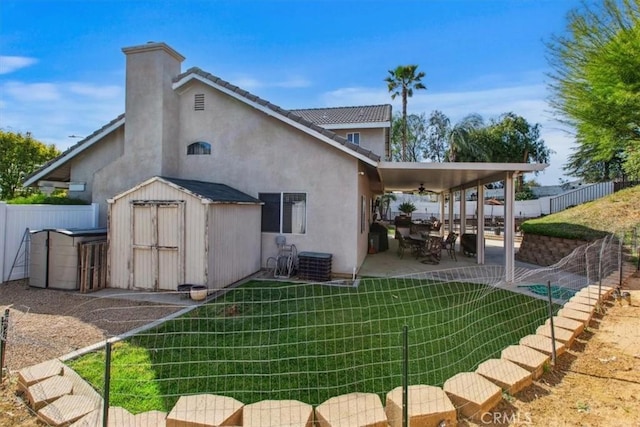 12427 Stardell Ln, Yucaipa, CA 92399 - rear view of property with a ceiling fan, a storage unit, a patio area, stucco siding, and an outdoor structure