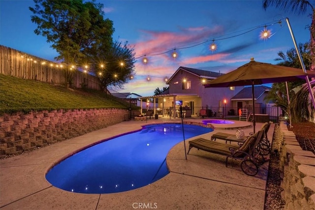 12427 Stardell Ln, Yucaipa, CA 92399 - pool at dusk with a fenced backyard, a patio, and a pool with connected hot tub