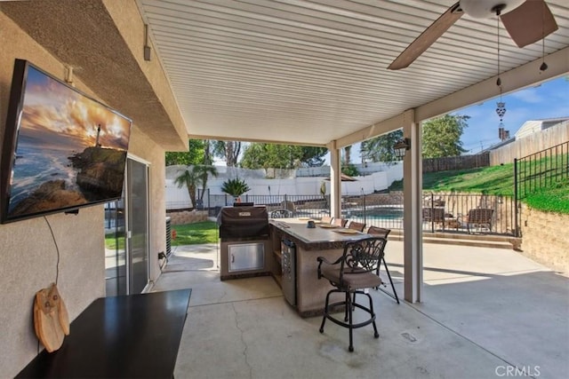 12427 Stardell Ln, Yucaipa, CA 92399 - view of patio featuring a fenced backyard, exterior bar, exterior kitchen, and ceiling fan