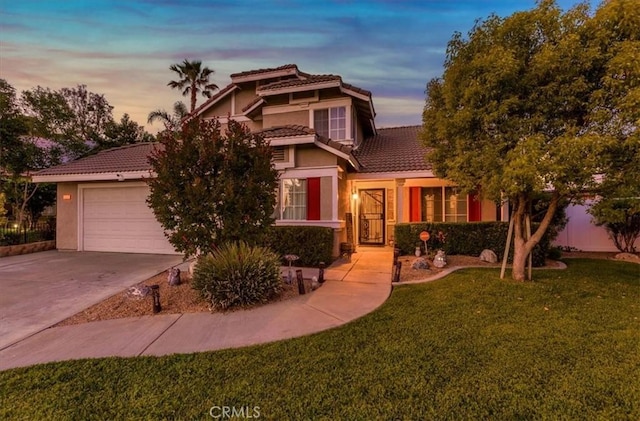 12427 Stardell Ln, Yucaipa, CA 92399 - view of front facade featuring a tile roof, a lawn, stucco siding, concrete driveway, and a garage