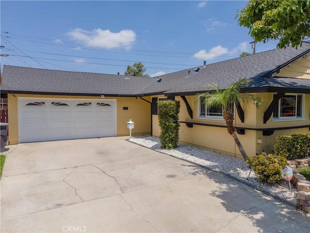 8529 Brunswick Ave, Riverside, CA 92504 - view of front of home with roof with shingles, an attached garage, concrete driveway, and stucco siding