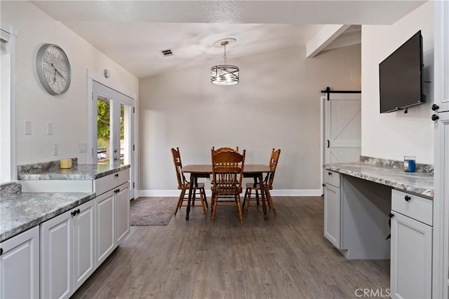 2245 Rancho Lomas Way, San Miguel, CA 93451 - dining space with a barn door, wood finished floors, baseboards, and vaulted ceiling