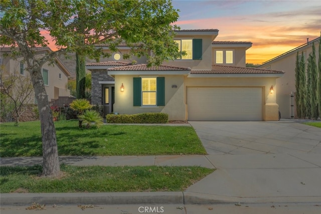 34130 Camelina St, Lake Elsinore, CA 92532 - mediterranean / spanish house featuring stucco siding, driveway, a tile roof, a front lawn, and a garage