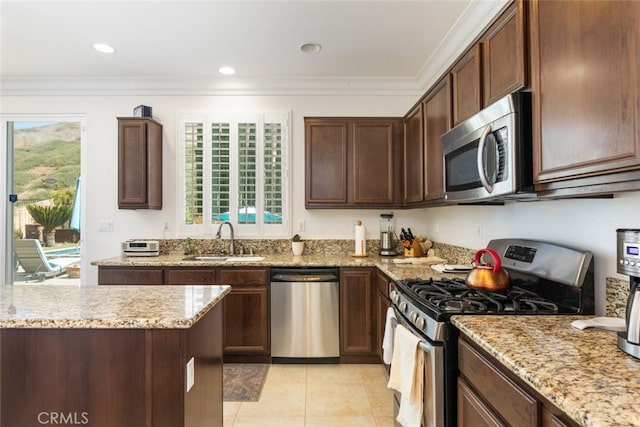 34130 Camelina St, Lake Elsinore, CA 92532 - kitchen featuring stainless steel appliances, a sink, light stone countertops, light tile patterned floors, and ornamental molding