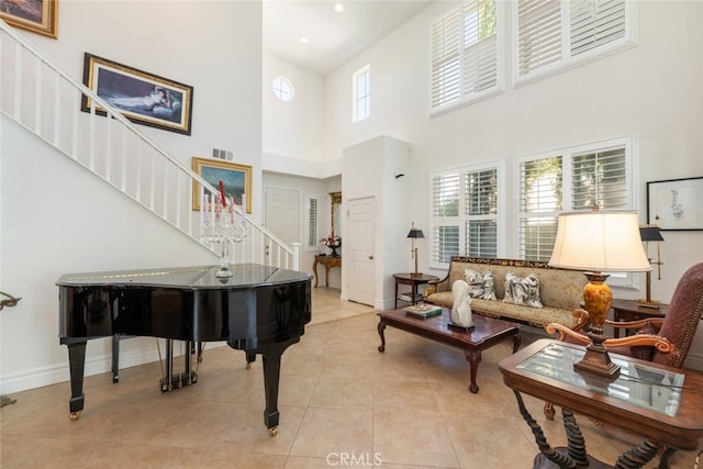 34130 Camelina St, Lake Elsinore, CA 92532 - living area with stairway, a high ceiling, light tile patterned flooring, baseboards, and recessed lighting