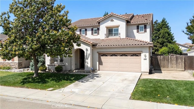 1689 Hometown Ln, Manteca, CA 95337 - mediterranean / spanish house with stucco siding, a tile roof, and concrete driveway