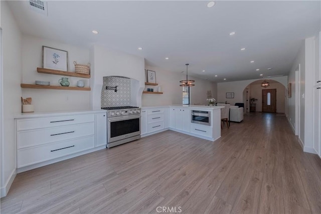 3448 Ferncroft Rd, Los Angeles, CA 90039 - kitchen with high end stove, open shelves, open floor plan, arched walkways, and a peninsula