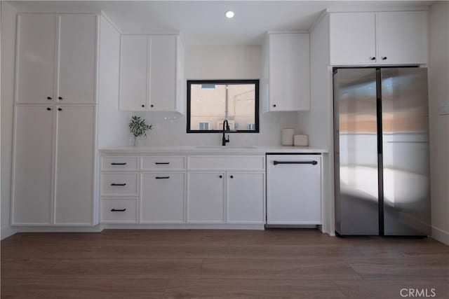 3448 Ferncroft Rd, Los Angeles, CA 90039 - kitchen with freestanding refrigerator, a sink, light wood-style floors, white cabinetry, and recessed lighting