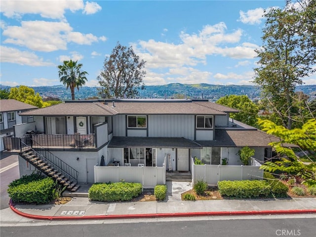 19836 White Spring Ln, Yorba Linda, CA 92886 - view of property featuring a fenced front yard, stairway, roof with shingles, and a mountain view