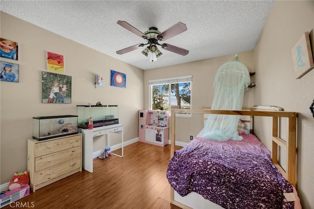 19836 White Spring Ln, Yorba Linda, CA 92886 - bedroom featuring wood finished floors, a textured ceiling, a ceiling fan, and baseboards