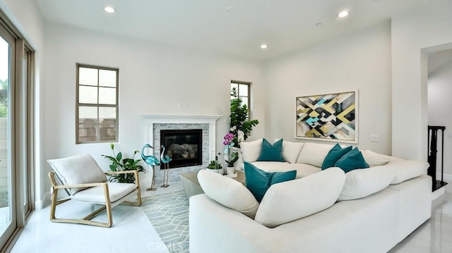 living area featuring recessed lighting and a glass covered fireplace