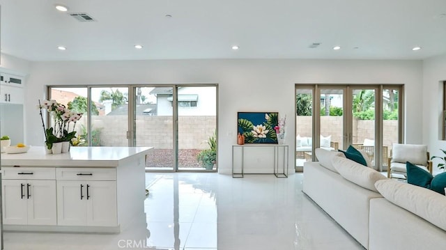 living area with recessed lighting and light tile patterned floors