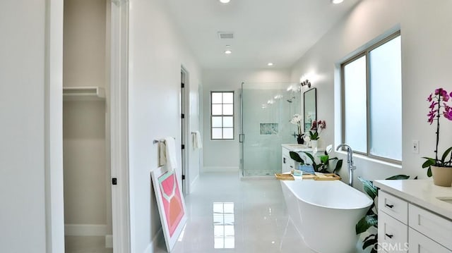 full bathroom with a stall shower, vanity, a freestanding bath, recessed lighting, and tile patterned floors