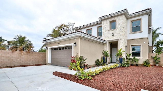view of front of property featuring stucco siding, driveway, fence, and a tile roof
