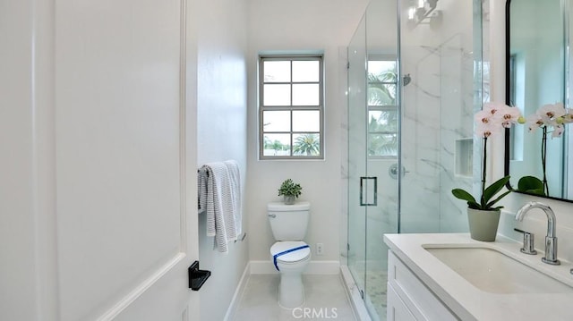 bathroom with toilet, a marble finish shower, vanity, and baseboards
