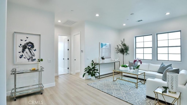 living room with wood finished floors, recessed lighting, and baseboards
