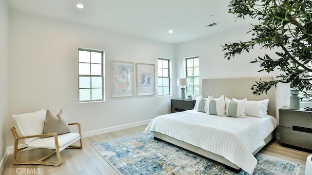 bedroom featuring light wood-style flooring, recessed lighting, and baseboards