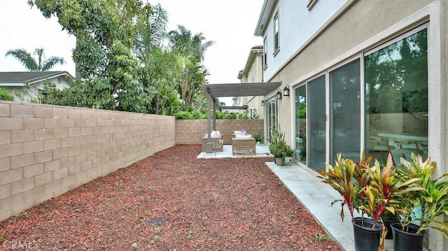 fenced backyard with a patio area
