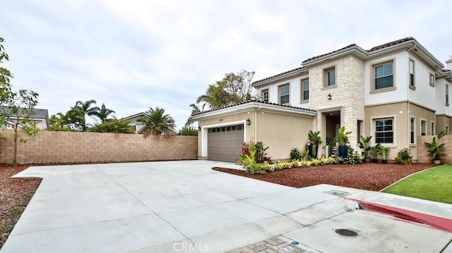 view of front facade with fence, stucco siding, a garage, driveway, and a tile roof