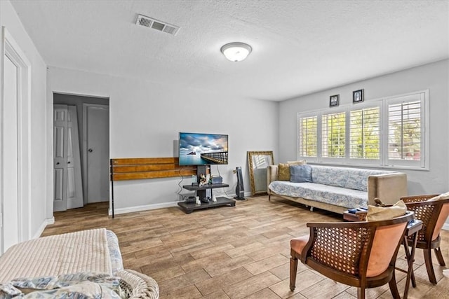 9502 Westminster Ave, Garden Grove, CA 92844 - living room featuring wood finished floors, a textured ceiling, and baseboards