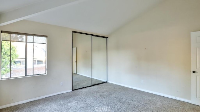 86069 Village Unit 69, Costa Mesa, CA 92626 - unfurnished bedroom with carpet floors, multiple windows, lofted ceiling, baseboards, and a closet