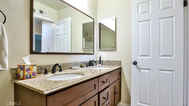 86069 Village Unit 69, Costa Mesa, CA 92626 - bathroom featuring double vanity and a textured wall