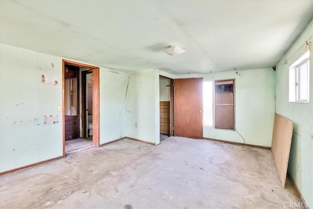 7037 Calapooya Way, Joshua Tree, CA 92252 - unfurnished bedroom featuring baseboards and concrete floors