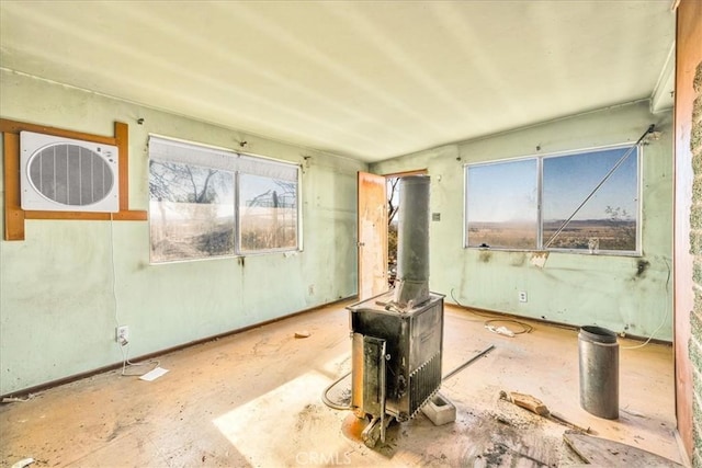 7037 Calapooya Way, Joshua Tree, CA 92252 - unfurnished room with a wood stove and healthy amount of natural light