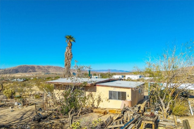 7037 Calapooya Way, Joshua Tree, CA 92252 - rear view of house featuring a mountain view and stucco siding