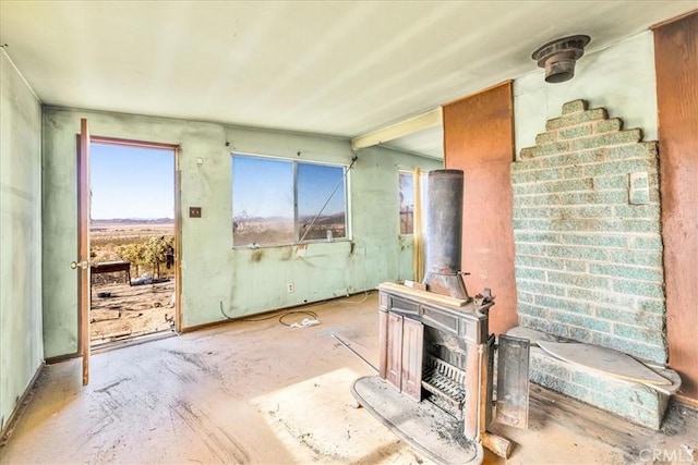 7037 Calapooya Way, Joshua Tree, CA 92252 - unfurnished living room featuring a wood stove