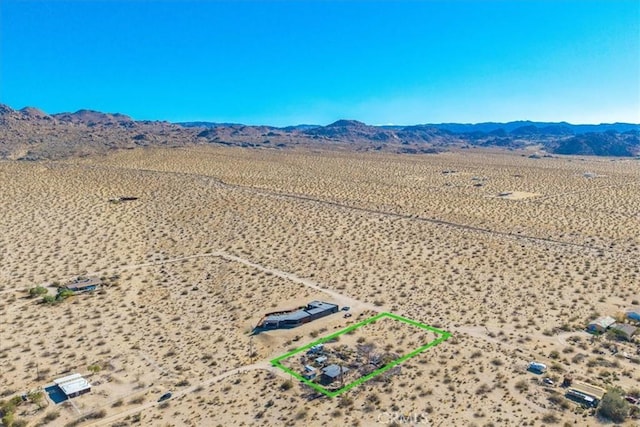 7037 Calapooya Way, Joshua Tree, CA 92252 - aerial view of sparsely populated area with a mountainous background, a desert landscape, and property boundaries highlighted