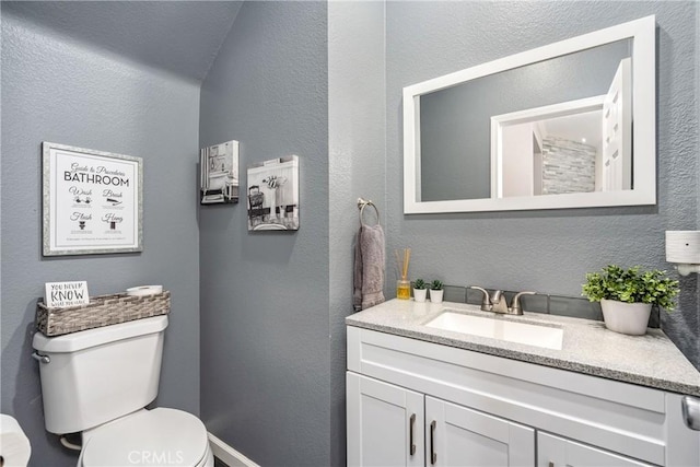 893 Whimbrel Way, Perris, CA 92571 - bathroom featuring toilet, vanity, and a textured wall